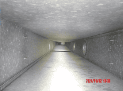 Interior view of a rectangular metal air duct with some dust visible on surfaces; date and time stamp at bottom right reads 2024/01/02 13:35. Captured during an Air Duct Cleaning inspection in Philadelphia, PA.